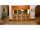 Modern kitchen features a breakfast bar with seating and wood cabinetry at 13878 Oak Forest N Blvd, Seminole, FL 33776