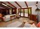Comfortable living room with beamed ceilings, wooden accents, and access to a patio at 13878 Oak Forest N Blvd, Seminole, FL 33776