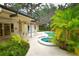 Relax and unwind in the screened-in pool and spa area surrounded by lush tropical landscaping at 13878 Oak Forest N Blvd, Seminole, FL 33776