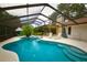 Relaxing screened-in pool and spa with lounge chairs and outdoor dining provide a resort-style experience at 13878 Oak Forest N Blvd, Seminole, FL 33776