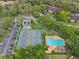 Aerial view of the community amenities: pool, tennis courts, and parking at 14107 Mossy Glen Ln # 203, Tampa, FL 33613