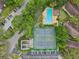 Aerial view showcasing the community pool, tennis courts, and ample parking at 14107 Mossy Glen Ln # 203, Tampa, FL 33613