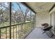 Cozy balcony with seating and a beautiful view of the green landscape with string lights at 14107 Mossy Glen Ln # 203, Tampa, FL 33613