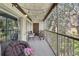 Relaxing balcony with comfortable seating, string lights, and views of the green landscape at 14107 Mossy Glen Ln # 203, Tampa, FL 33613