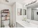Well-lit bathroom featuring a toilet, sink vanity, large mirror, and walk-in shower at 14107 Mossy Glen Ln # 203, Tampa, FL 33613