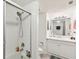 All-white bathroom featuring a shower with glass door and a modern vanity with storage at 14107 Mossy Glen Ln # 203, Tampa, FL 33613