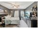 Comfortable bedroom with modern decor, ceiling fan, and sliding glass door to a balcony at 14107 Mossy Glen Ln # 203, Tampa, FL 33613