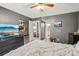 Spacious bedroom with dark gray walls, tiled floor, and view of hallway bathroom at 14107 Mossy Glen Ln # 203, Tampa, FL 33613