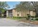 Inviting condo exterior featuring screened balconies and lush landscaping at 14107 Mossy Glen Ln # 203, Tampa, FL 33613
