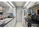 Clean kitchen featuring tiled floor, white cabinets, and view of dining room at 14107 Mossy Glen Ln # 203, Tampa, FL 33613