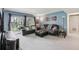 Open-concept living space featuring comfortable furniture, and balcony access at 14107 Mossy Glen Ln # 203, Tampa, FL 33613