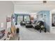 Spacious living room with blue walls, plush sofas and sliding glass doors to the balcony at 14107 Mossy Glen Ln # 203, Tampa, FL 33613