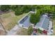 This home features an aerial view of its well-maintained lawn, solar panels, and charming residential neighborhood at 15100 Avalon Ave, Clearwater, FL 33760
