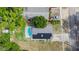 Aerial view of a home with a pool and solar panels on the roof at 15100 Avalon Ave, Clearwater, FL 33760