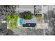Aerial view of a home with a pool and solar panels on the roof at 15100 Avalon Ave, Clearwater, FL 33760
