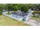 Aerial view of a home with solar panels, fenced yard and a kidney-shaped swimming pool at 15100 Avalon Ave, Clearwater, FL 33760