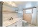 Well-lit bathroom featuring a marble countertop, modern fixtures, and tiled shower at 15100 Avalon Ave, Clearwater, FL 33760