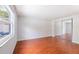 Bright and spacious bedroom with a large window, hardwood floors, and a mirrored closet at 15100 Avalon Ave, Clearwater, FL 33760