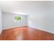 Empty bedroom featuring hardwood floors and a large window, ready for personalization at 15100 Avalon Ave, Clearwater, FL 33760