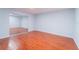 Spacious bedroom with hardwood floors and a mirrored closet, offering ample space at 15100 Avalon Ave, Clearwater, FL 33760