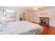 Cozy bedroom with an electric fireplace and a view of the bed with mirrored closet at 15100 Avalon Ave, Clearwater, FL 33760