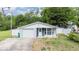 Charming single-story home featuring a well-manicured lawn and an attached one-car garage at 15100 Avalon Ave, Clearwater, FL 33760