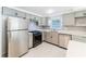 Charming kitchen with stainless steel appliances, sleek cabinets, and white counter tops at 15100 Avalon Ave, Clearwater, FL 33760