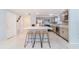 Modern kitchen with grey cabinets, stainless steel appliances, and a center island with seating at 15100 Avalon Ave, Clearwater, FL 33760