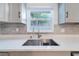 Close-up of a modern kitchen sink with stainless steel faucet and a bright window view at 15100 Avalon Ave, Clearwater, FL 33760