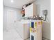 Functional laundry room with washer, dryer, water heater, and built-in cabinets at 15100 Avalon Ave, Clearwater, FL 33760