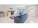 The cozy living room showcases a large window, modern furniture, and white marble flooring at 15100 Avalon Ave, Clearwater, FL 33760