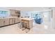 Open-concept kitchen and living room with a stylish island, counter seating, and modern design at 15100 Avalon Ave, Clearwater, FL 33760