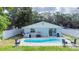Backyard pool with lush landscaping and seating perfect for outdoor relaxation at 15100 Avalon Ave, Clearwater, FL 33760