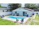 Enjoy outdoor living in this home featuring a private pool and seating area, perfect for relaxation and entertaining at 15100 Avalon Ave, Clearwater, FL 33760