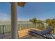 Relaxing waterfront balcony with comfortable lounge chair, offering picturesque views of the water and surroundings at 15805 Redington Dr, Redington Beach, FL 33708