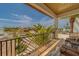 Expansive balcony with comfortable seating, showcasing lush landscaping and neighborhood views at 15805 Redington Dr, Redington Beach, FL 33708