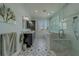 Modern bathroom featuring a glass-enclosed shower and a double vanity with a picturesque window view at 15805 Redington Dr, Redington Beach, FL 33708