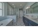 Well-appointed bathroom with a glass shower, stylish vanity, and patterned tile flooring at 15805 Redington Dr, Redington Beach, FL 33708