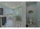 Bright bathroom boasting a glass shower, patterned floor, and stylish fixtures at 15805 Redington Dr, Redington Beach, FL 33708