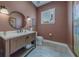 This bathroom features a unique wood vanity, round mirror, and neutral earth tone colors at 15805 Redington Dr, Redington Beach, FL 33708