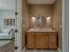 Stylish bathroom features a wooden vanity, decorative mirror, sconces and artistic tile flooring at 15805 Redington Dr, Redington Beach, FL 33708
