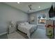 Serene bedroom with soft colors, a metal frame bed and a view from the window at 15805 Redington Dr, Redington Beach, FL 33708