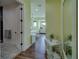 Spacious bedroom with a glimpse into a sleek bathroom featuring modern fixtures at 15805 Redington Dr, Redington Beach, FL 33708