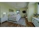 A charming bedroom with a ceiling fan, a window view, and light walls at 15805 Redington Dr, Redington Beach, FL 33708