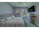 This bedroom features soft colors, a metal frame bed and a view from the window at 15805 Redington Dr, Redington Beach, FL 33708