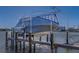 Boat covered in tarp on boat lift at private residence at 15805 Redington Dr, Redington Beach, FL 33708