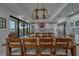 Charming dining area featuring wood table and seating, with kitchen and balcony access at 15805 Redington Dr, Redington Beach, FL 33708