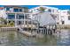 Waterfront property with a private boat dock, lift and amazing backyard views of a large home at 15805 Redington Dr, Redington Beach, FL 33708