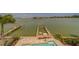 Beautiful waterfront view showcasing boat dock featuring pristine water and lush landscaping at 15805 Redington Dr, Redington Beach, FL 33708