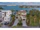Elegant waterfront home with lush landscaping, a circular driveway and three-car garage at 15805 Redington Dr, Redington Beach, FL 33708